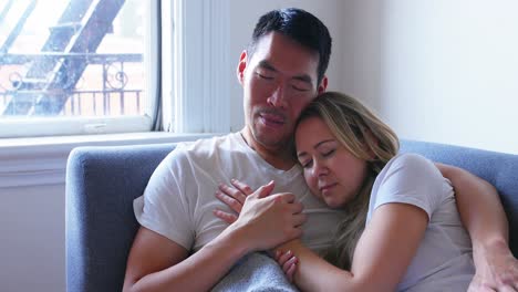 Couple-relaxing-on-sofa