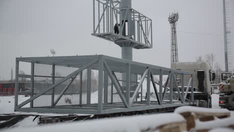 el transporte de una gran estructura metálica para un cartel en invierno