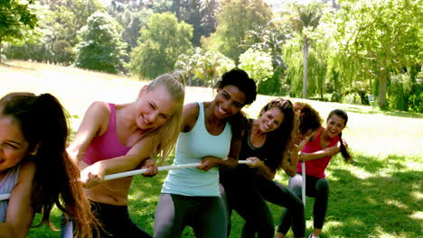 group of fit women pulling a rope