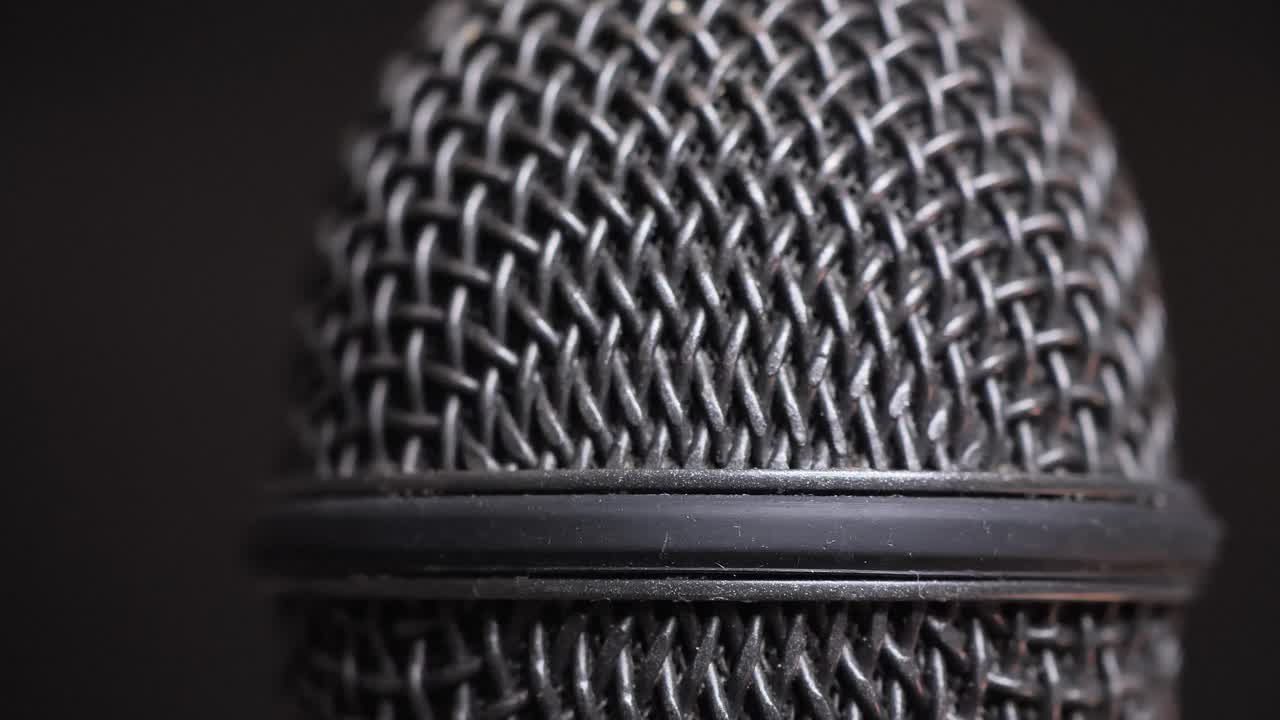 Extreme closeup of old dirty stereo microphone head, spinning. Macro shot.  Scene B.