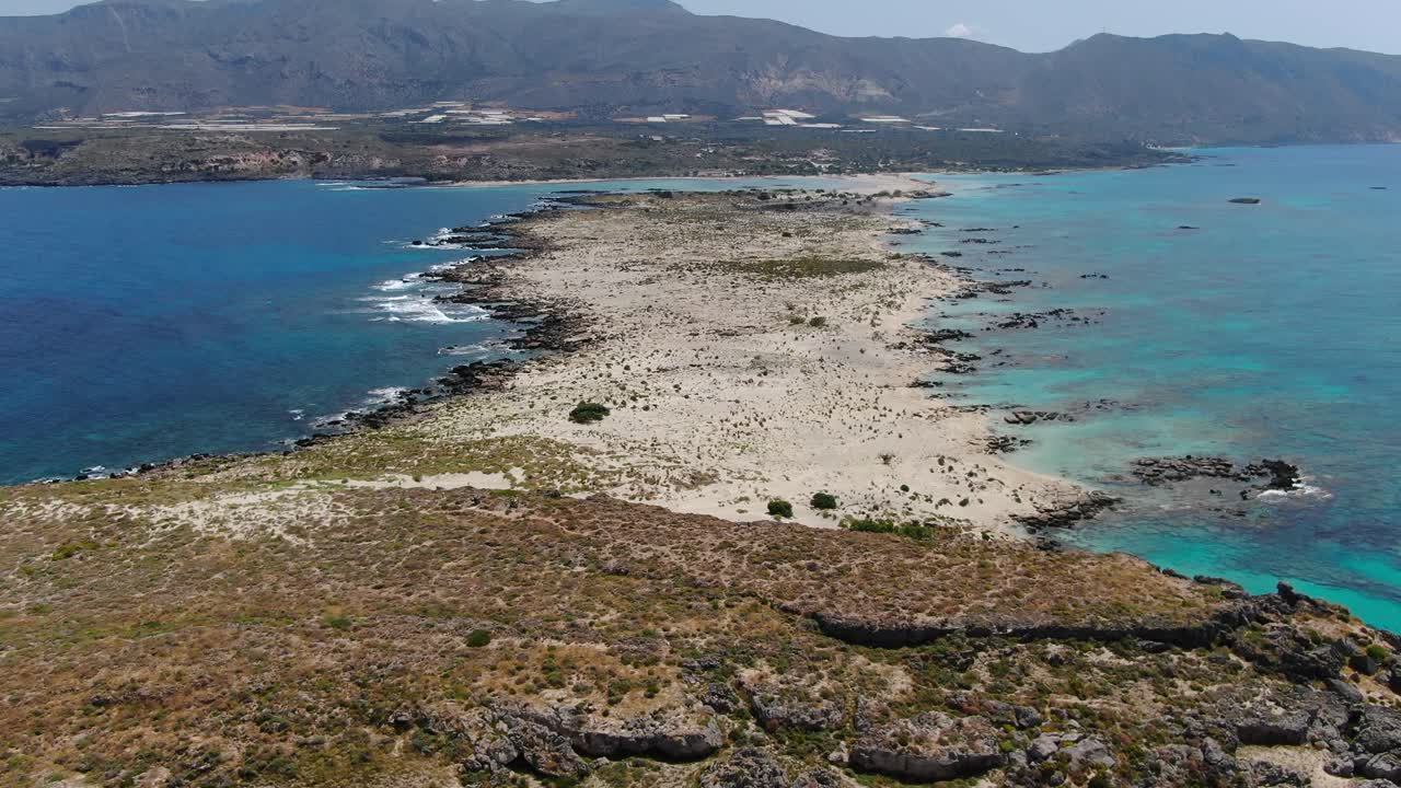 Elafonissi peninsula in Crete Island Greece full view with Church Agia Irini at left, Aerial dolly out reveal shot