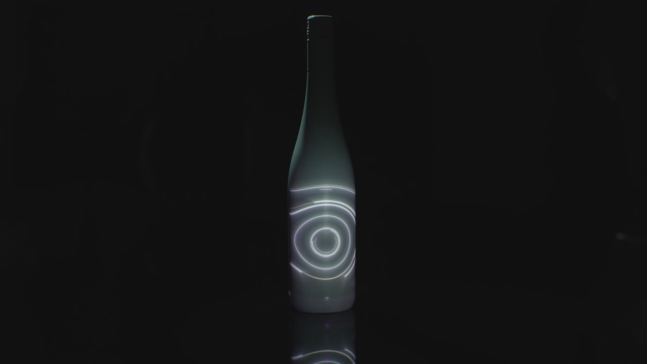 A Spinning Light Is Projected Onto A White Bottle