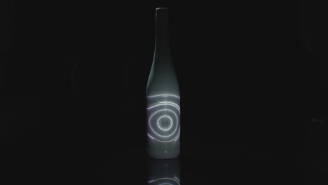 a spinning light is projected onto a white bottle