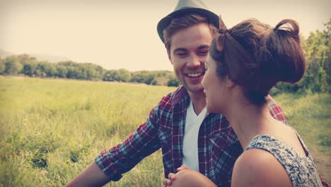 Happy-couple-sitting-on-the-grass