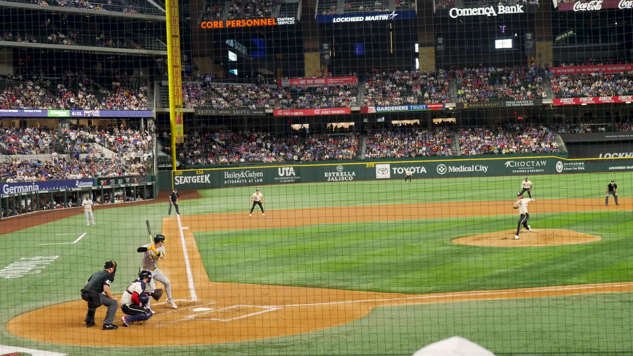 Slow motion landscape of baseball batter hitting ball and running at major league game pitch Arlington Globe Life Field stadium in Texas USA America sports players match