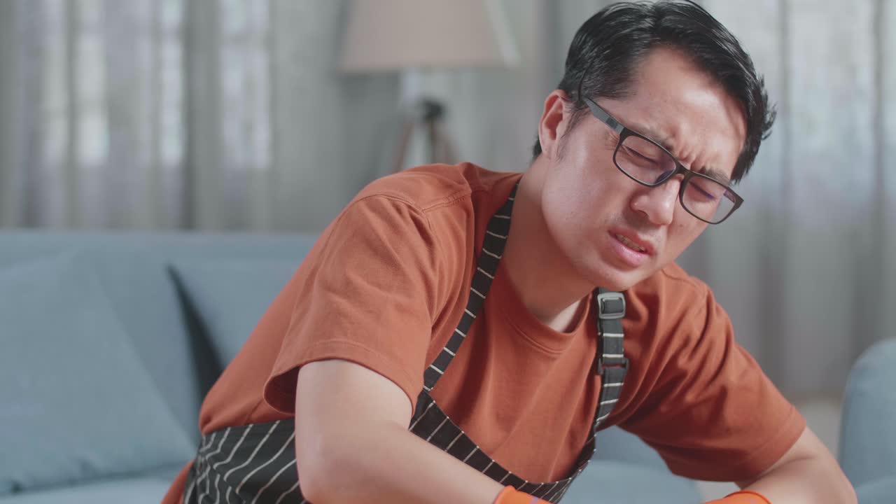 청소 할 때 허리 통증으로 고통 받는 남자