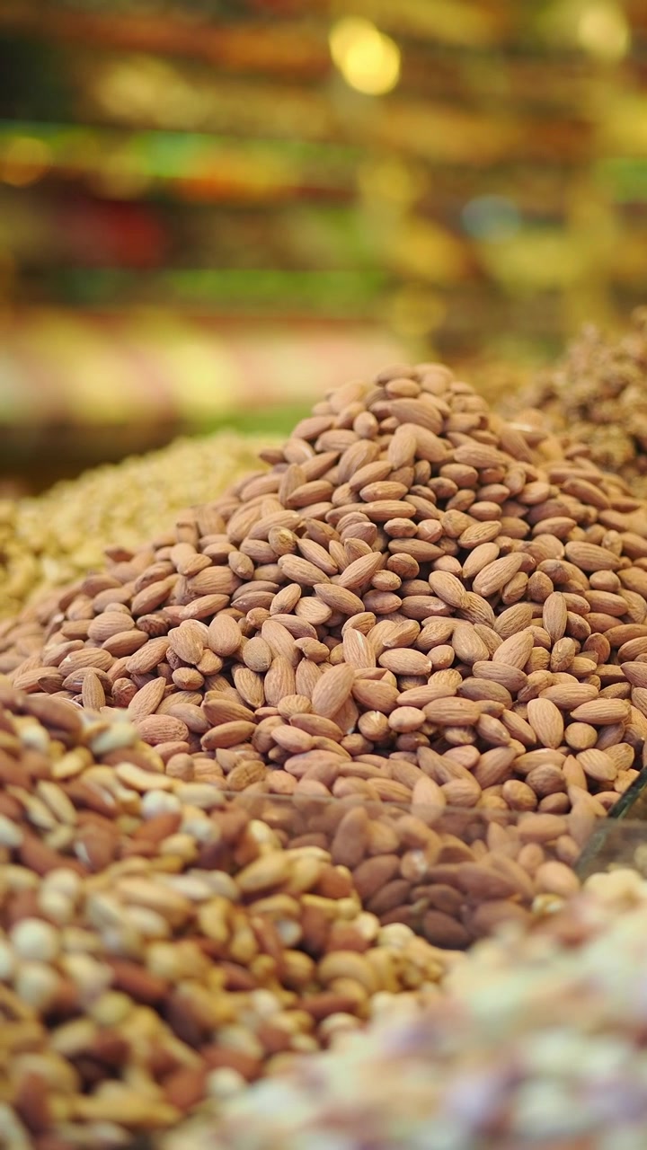 Piles of Fresh Almonds and Assorted Nuts at a Market