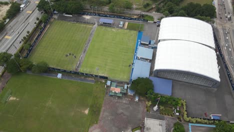 dato' suleiman mohd noor indoor sports facility looking down on the soccer fields and building from above with an aerial drone in malaysia