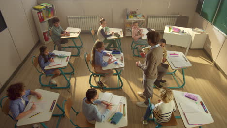 Profesor-Enseñando-A-Niños-En-El-Aula.-Estudiantes-Inteligentes-Recibiendo-Educación