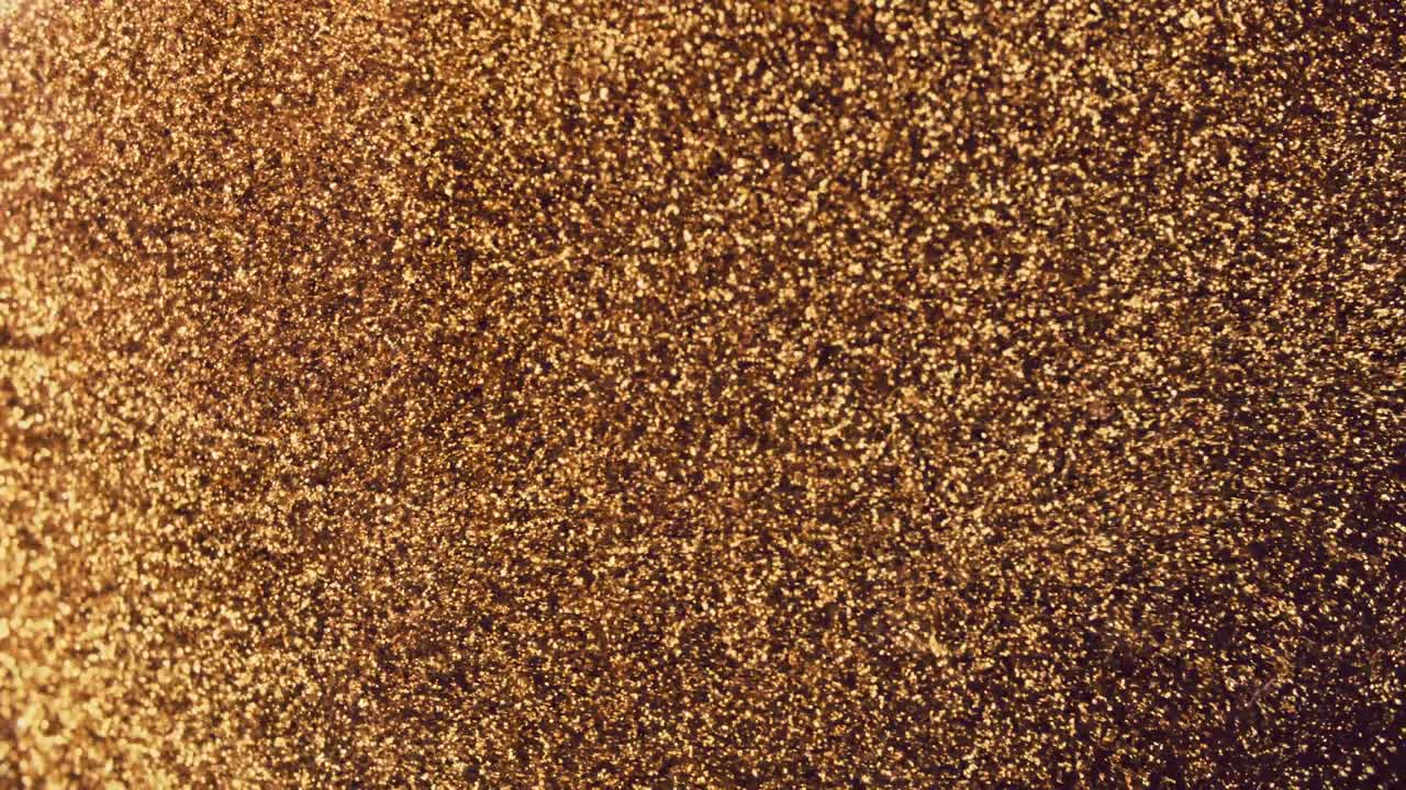 Abstract golden particles with blurred defocused bokeh moves chaos, snow flakes