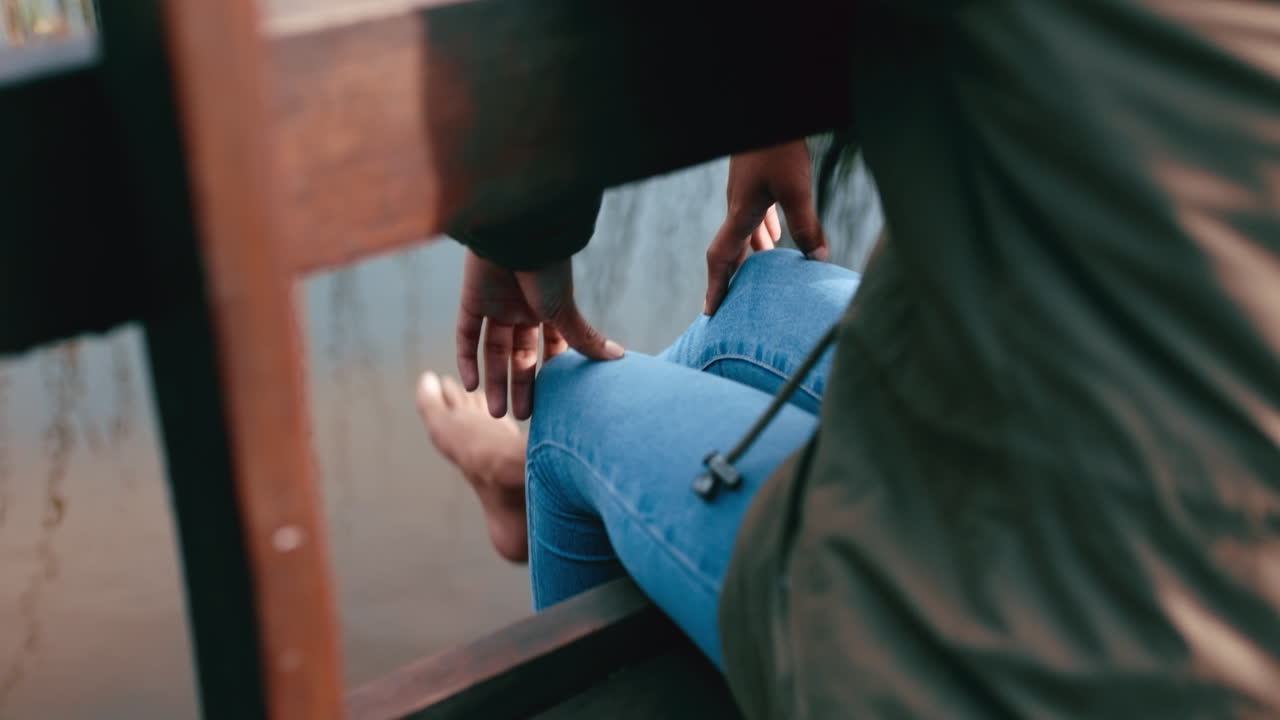 Closeup of a woman's legs hanging over the edge