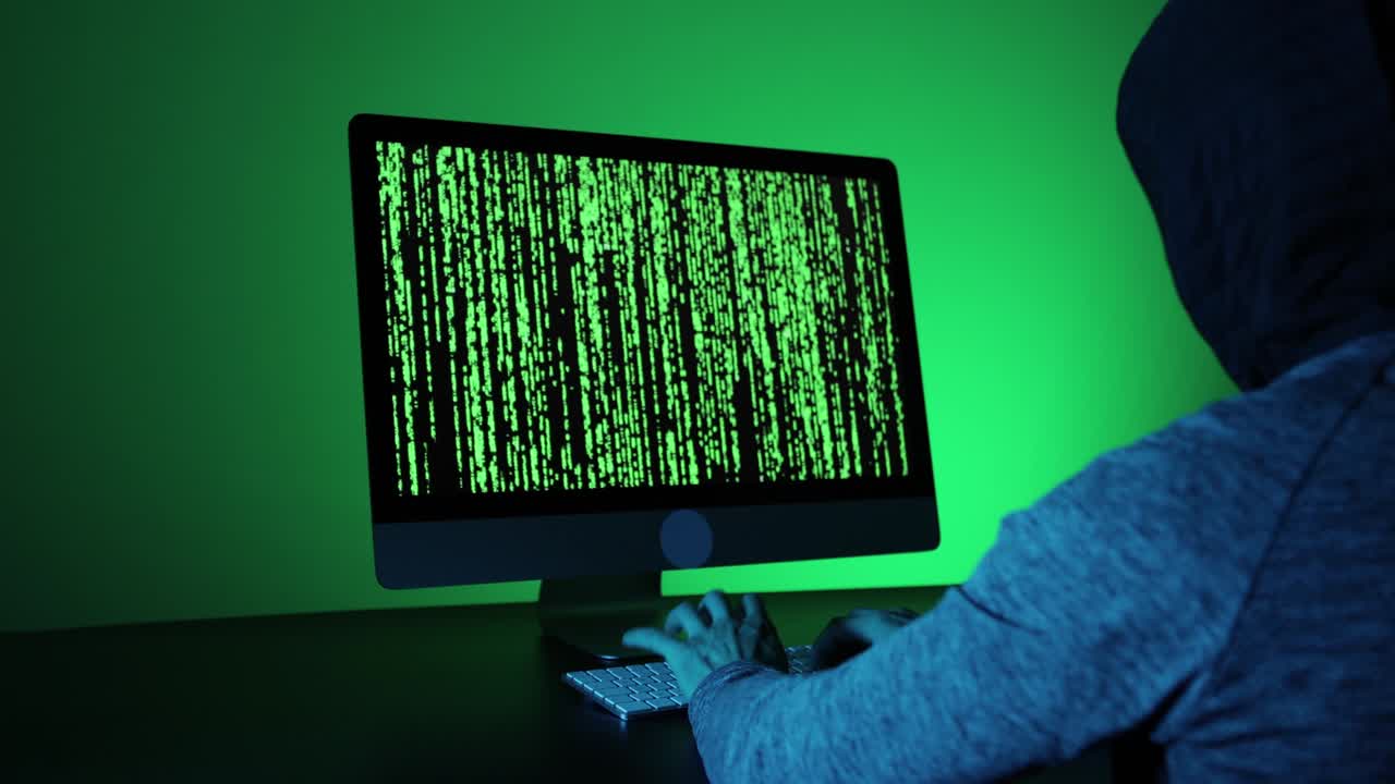 Unrecognizable man hacking in a dark room.