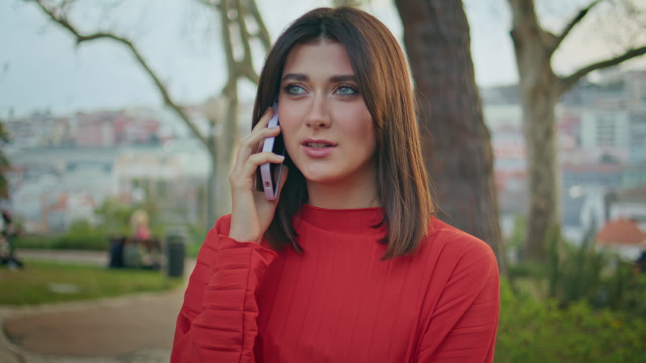Relaxed woman talking cellphone resting city park closeup. Girl waiting friend