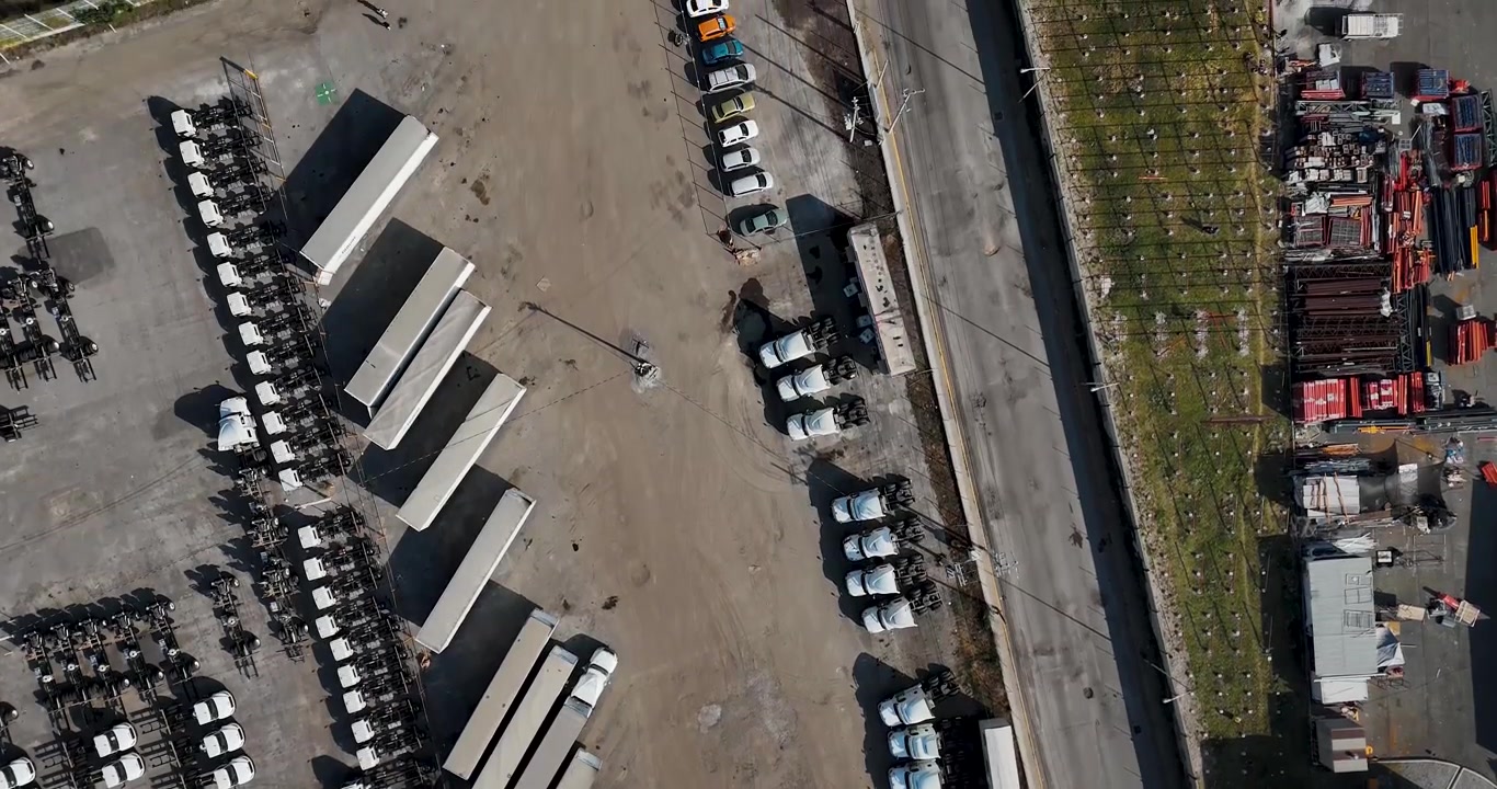 Aerial overhead shot of a maneuvering yard and parking area for cargo trailers in an industrial zone north of Mexico City