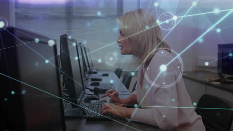 network connections and data processing animation over woman working on computer