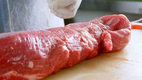 butcher tying meat with thread in butcher shop 4k