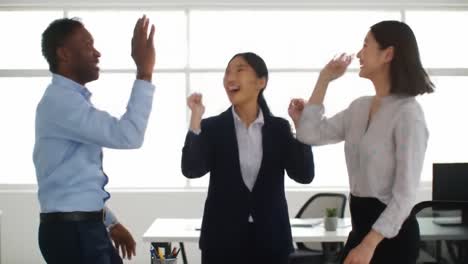 colleagues express excitement and happiness together as they celebrate a milestone achievement at work. the atmosphere is vibrant and uplifting in a modern office setting.