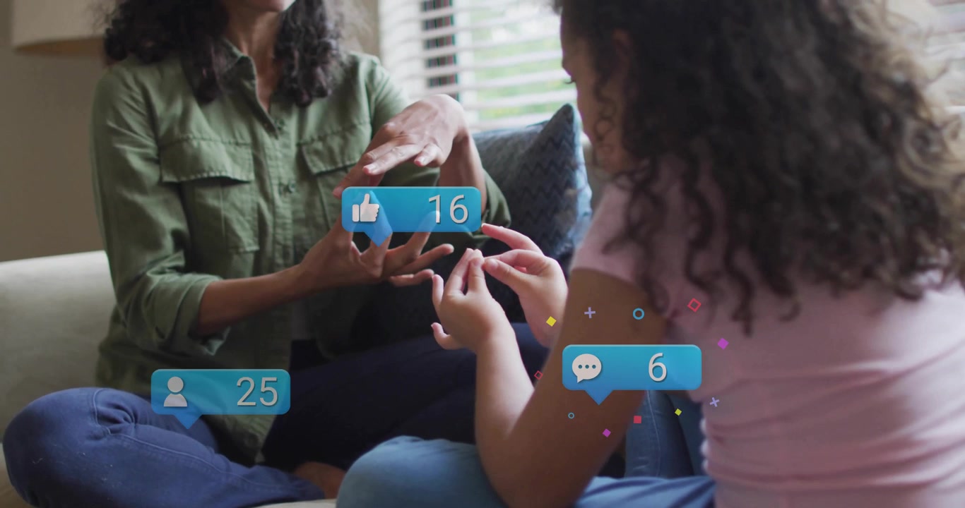 Mom teaching daughter signing gesture at home, generating animated likes comments hearts followers
