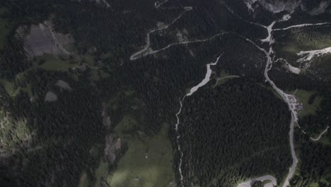 drone video with a descriptive recoil plane, over a sella pass, with a mountain on the horizon
