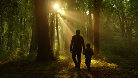 father and child walking through a sunlit forest