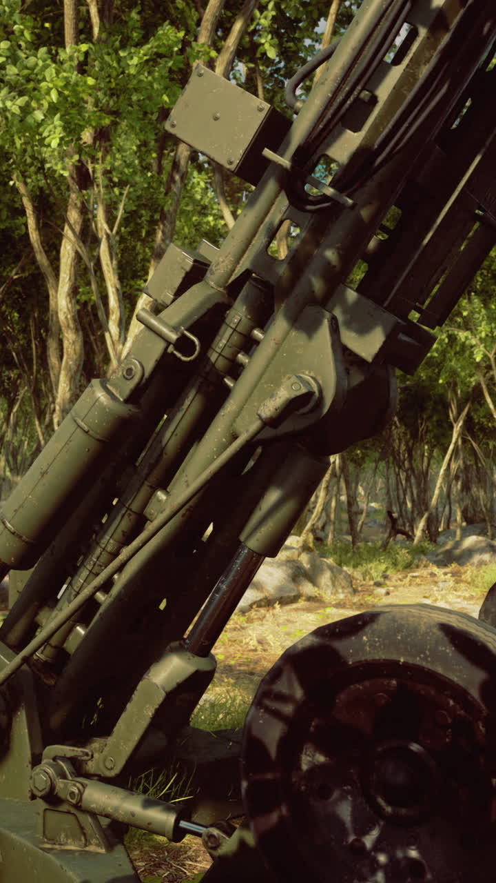 Military artillery positioned among the trees in a dense forest environment