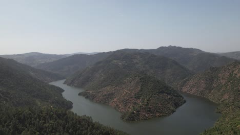 aerial view of tua river winding between forested hills