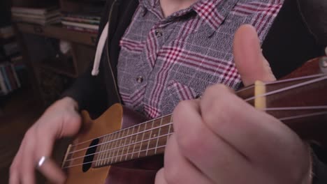 ukulele being played by person