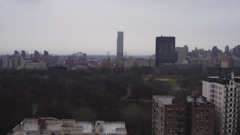 stationary shot of new york city from a rooftop on a gray rainy day overlooking central park