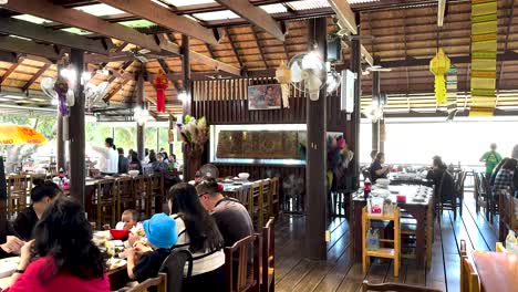 people enjoying meals in a thai-style restaurant