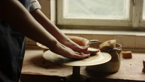 woman learning handicraft in pottery