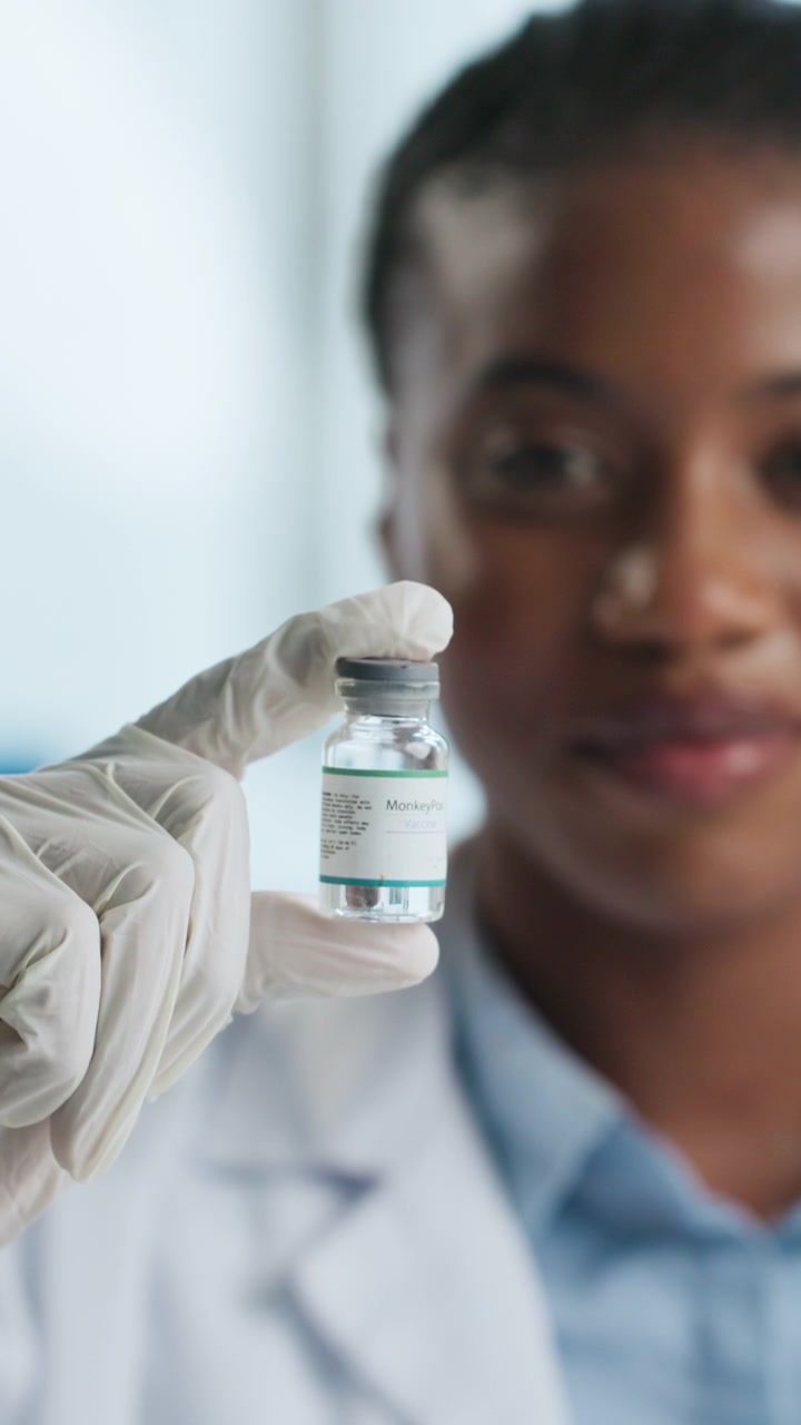Scientist Holding a Monkeypox Vaccine Vial in a Laboratory