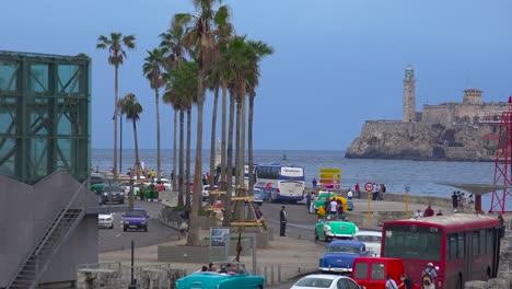 classic old cars and horse carts are driven through the colorful streets of havana cuba 2