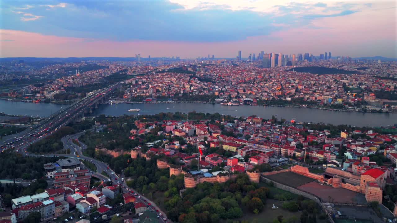Fatih Istanbul Turkey Türkiye the Golden Horn Blue Mosque temple Hagia Sophia Grand Mosque aerial drone sunset cityscape buildings Bosphorus Strait river ferries cars traffic harbor backwards pan up