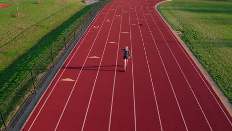 A-teen-girl-athlete-walks-track-and-cools-down-after-a-run