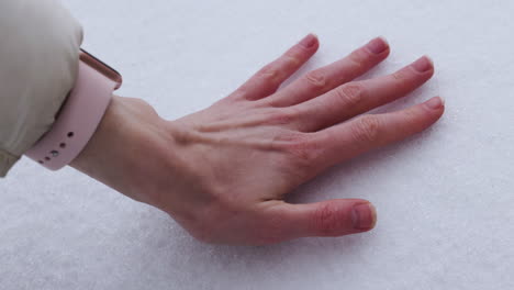 hands touching the snow