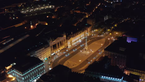 Aerial-night-view-of-Monumento-aos-Restauradores-on-public-square-with-VIP-Executive-Eden-Aparthotel-building-in-Lisbon,-Portugal