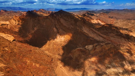 part of the brown mountain shaded by the big cloud. dry mojave landscape from drone footage.