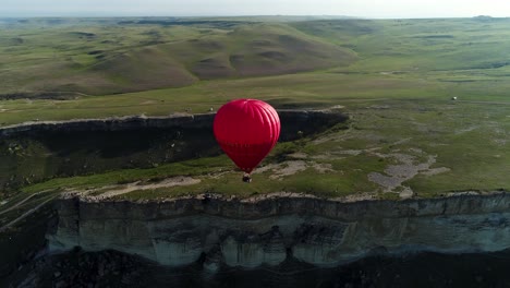 hot air balloon over a mountain valley