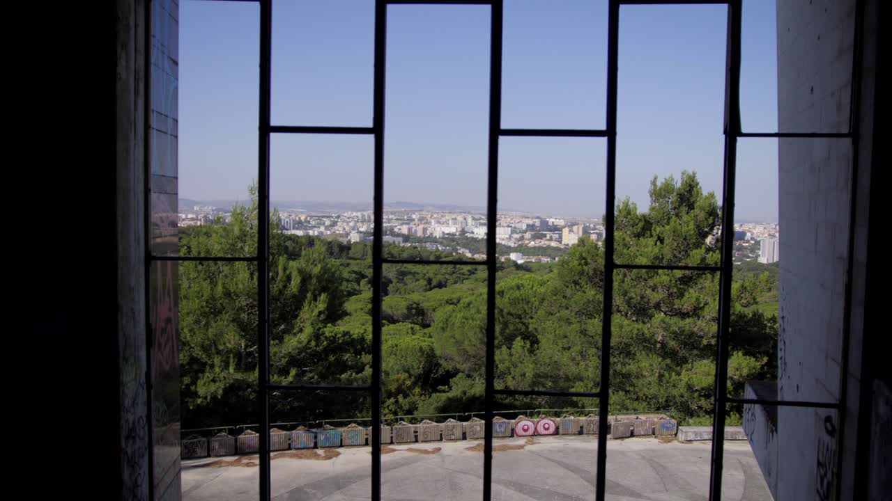 View through a window in Lisbon to the city from Restaurante Panorâmico De Monsanto