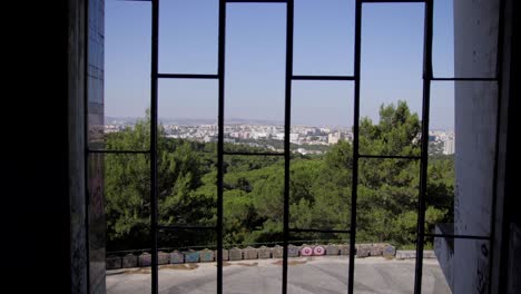 view through a window in lisbon to the city from restaurante panorâmico de monsanto