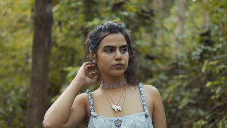 a slow motion shot of a model in a forest during the day