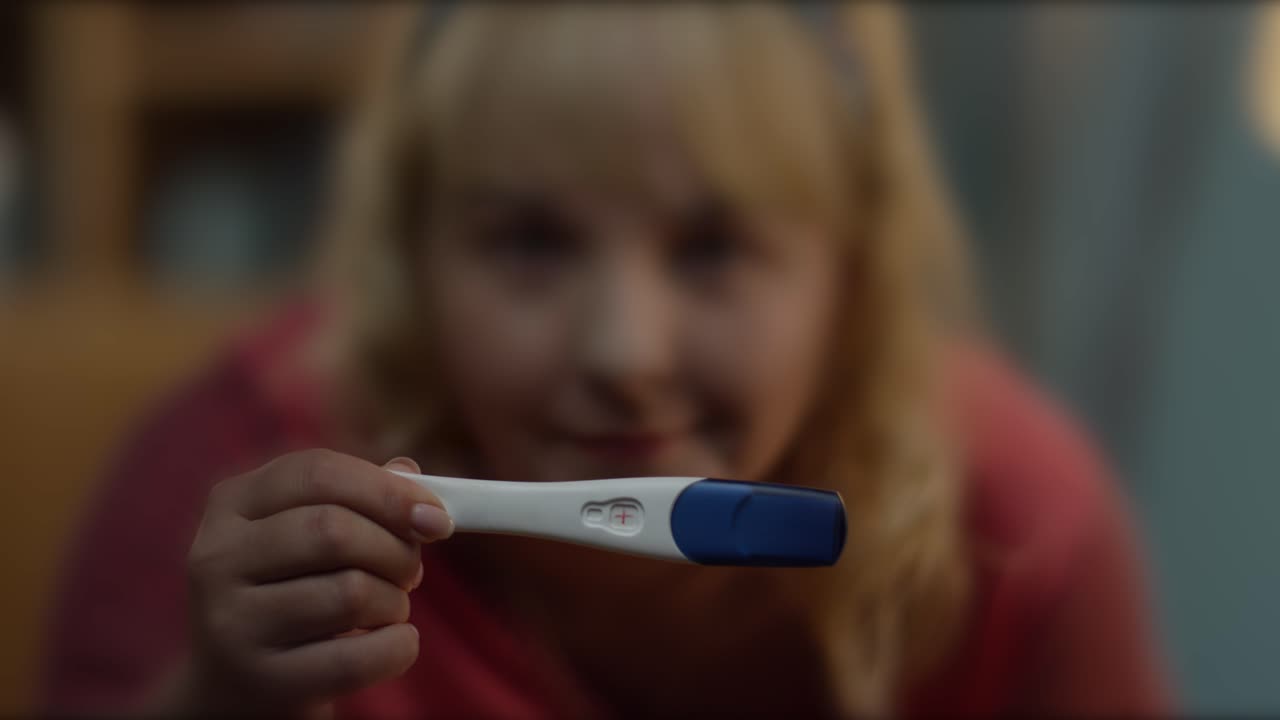 Donna con un test di gravidanza positivo
