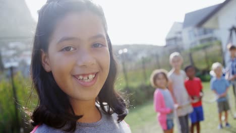 Portrait-of-happy-girl-standing-in-backyard-4k