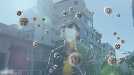 animation of covid 19 virus cells over woman wearing face mask using smartphone