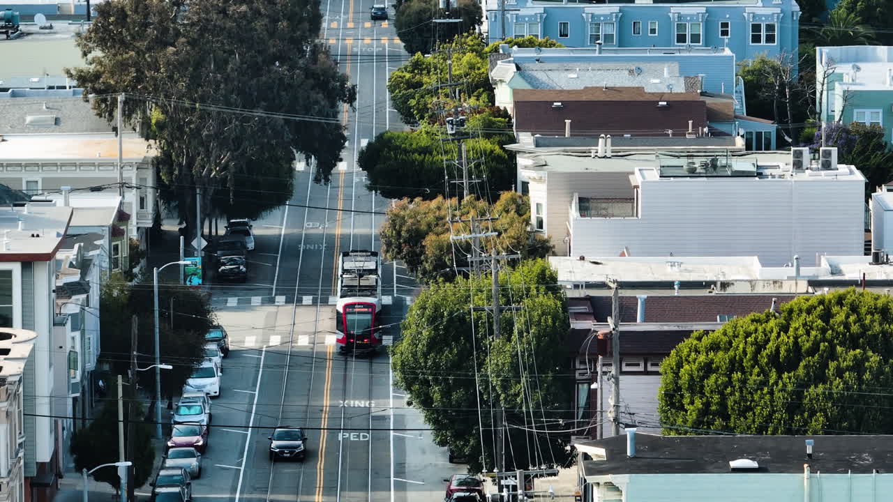 Aerial telezoom of a Muni train on the streets of San Francisco, sunny USA