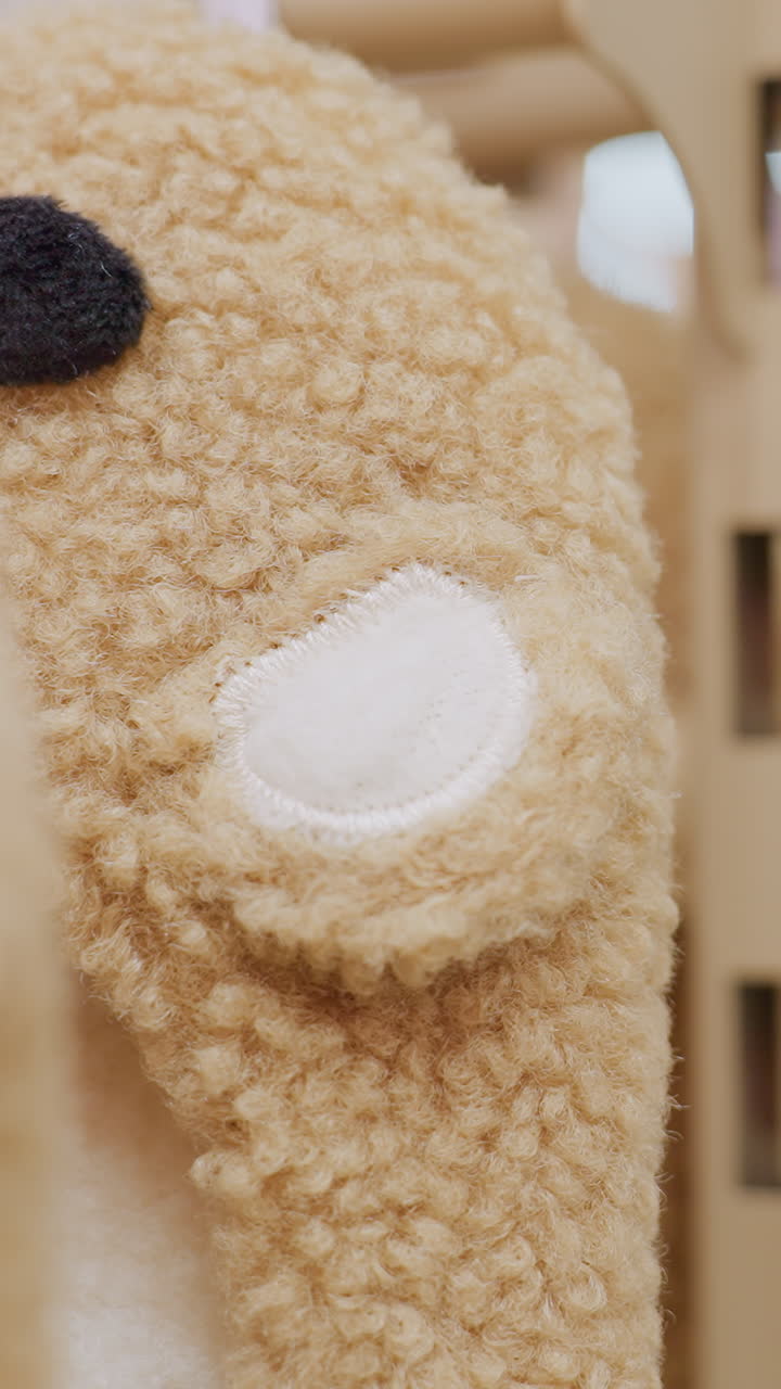 Close-up of a toy with soft bokeh effect, while people walk in the background in a busy mall, creating a lively and dynamic shopping atmosphere