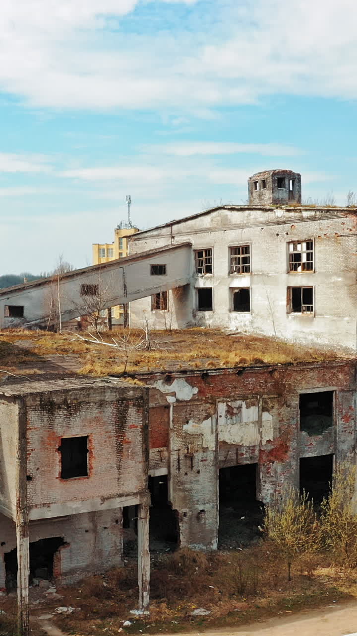 Abandoned industrial building. Ruins of an old factory. Aerial view Vertical video