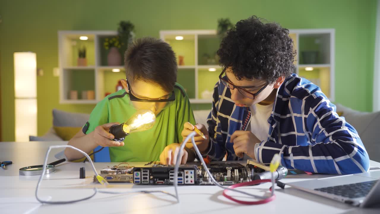 Two student kids who are curious about technology. He works at home.
