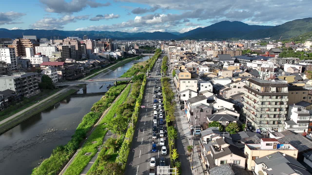 Riverside Cityscape With Traffic By The Kamo River In Inner City Of Kyoto, Japan. aerial shot