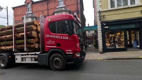 a logging truck maneuvers through oxford's busy streets